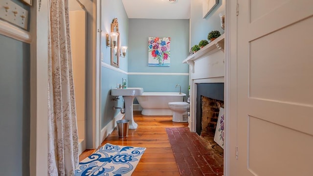 111 Main St S, Bridgewater, VA 22812 - full bath with hardwood / wood-style flooring, a fireplace, a freestanding bath, and toilet