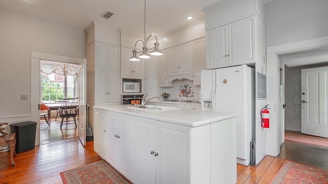 111 Main St S, Bridgewater, VA 22812 - kitchen with white appliances, light wood finished floors, light countertops, a chandelier, and recessed lighting
