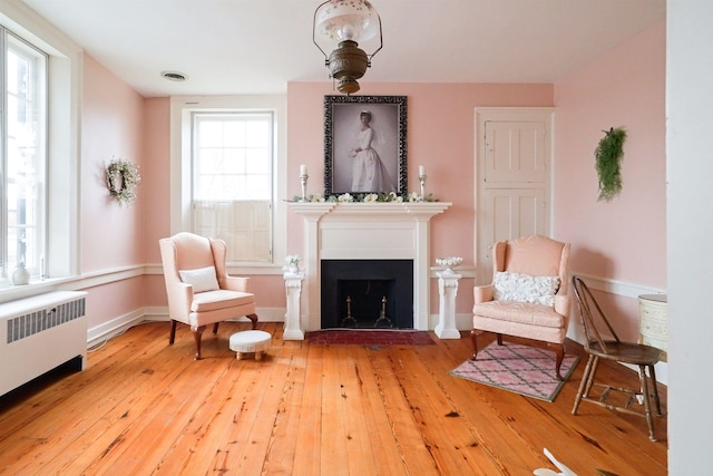 111 Main St S, Bridgewater, VA 22812 - sitting room featuring radiator heating unit, hardwood / wood-style floors, a fireplace with flush hearth, and baseboards