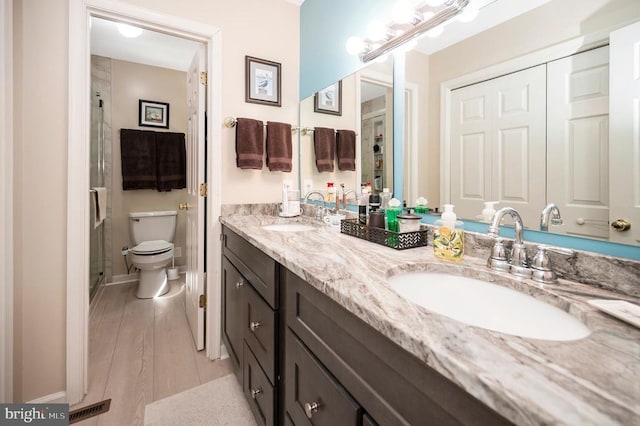 10415 Shaw Dr, Spotsylvania, VA 22553 - bathroom featuring double vanity, a stall shower, and wood finished floors