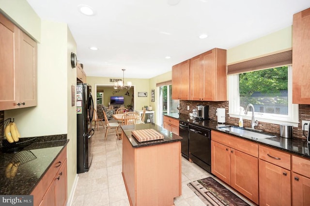 10415 Shaw Dr, Spotsylvania, VA 22553 - kitchen with black appliances, a center island, a chandelier, decorative backsplash, and dark stone counters