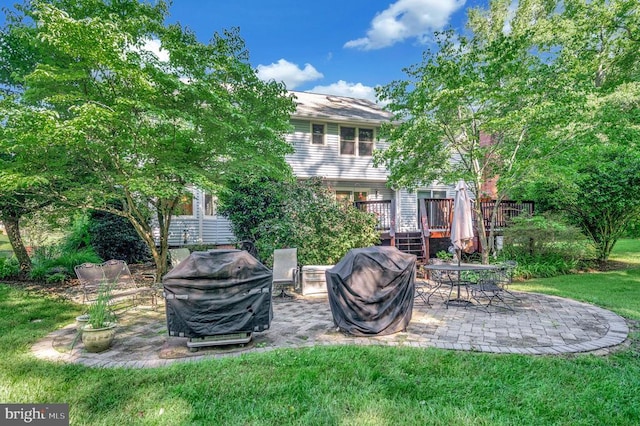 10415 Shaw Dr, Spotsylvania, VA 22553 - view of grassy yard featuring a patio and a wooden deck
