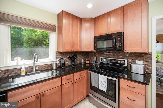 10415 Shaw Dr, Spotsylvania, VA 22553 - kitchen with black microwave, electric range, decorative backsplash, dark stone countertops, and plenty of natural light