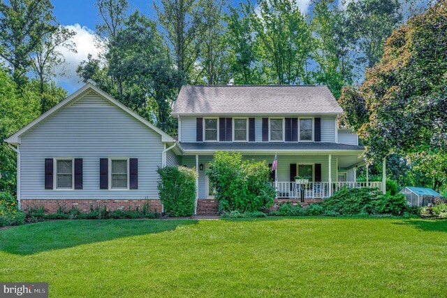 10415 Shaw Dr, Spotsylvania, VA 22553 - view of front of home featuring a front yard, covered porch, an exterior structure, and an outbuilding
