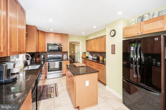 10415 Shaw Dr, Spotsylvania, VA 22553 - kitchen featuring black appliances, decorative backsplash, a center island, dark stone counters, and recessed lighting
