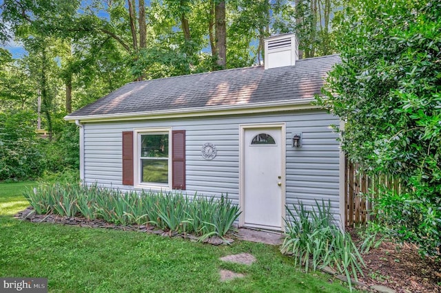 10415 Shaw Dr, Spotsylvania, VA 22553 - new england style home featuring a chimney, a front lawn, roof with shingles, and an outdoor structure