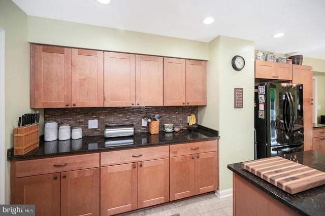 10415 Shaw Dr, Spotsylvania, VA 22553 - kitchen with freestanding refrigerator, decorative backsplash, dark stone counters, and recessed lighting