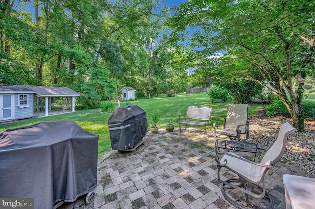 10415 Shaw Dr, Spotsylvania, VA 22553 - view of patio / terrace with grilling area, a storage unit, and view of scattered trees