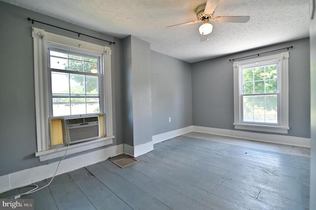 3150 Ida Rd, Luray, VA 22835 - empty room with a textured ceiling, healthy amount of natural light, cooling unit, a ceiling fan, and hardwood / wood-style flooring