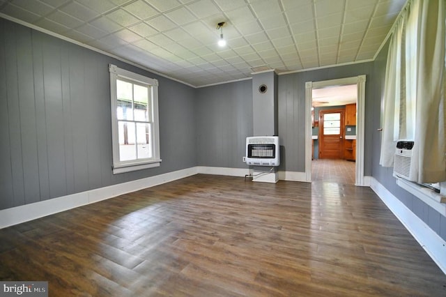 3150 Ida Rd, Luray, VA 22835 - unfurnished living room featuring heating unit, ornamental molding, wood finished floors, and a wood stove