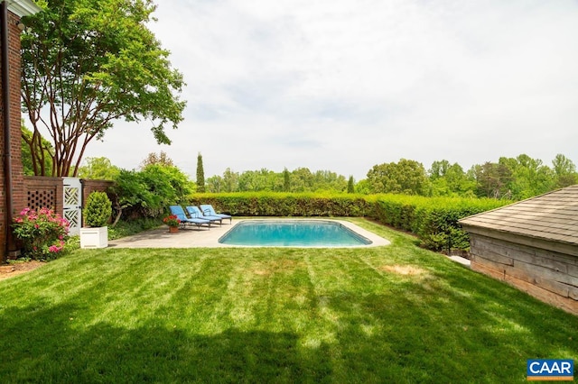 outdoor pool featuring a patio area and a lawn