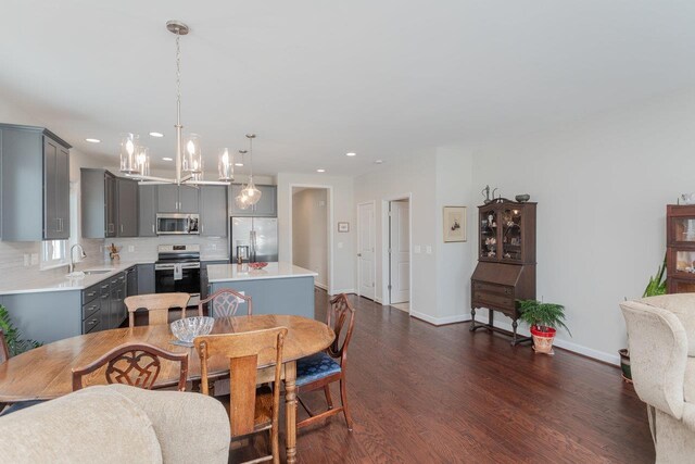 dining area featuring dark hardwood / wood-style floors and sink