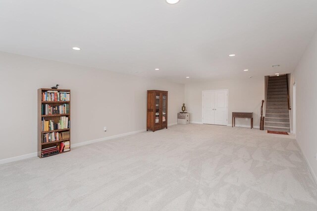 basement featuring light carpet