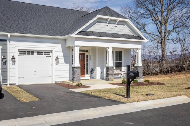 craftsman-style house featuring a garage and covered porch