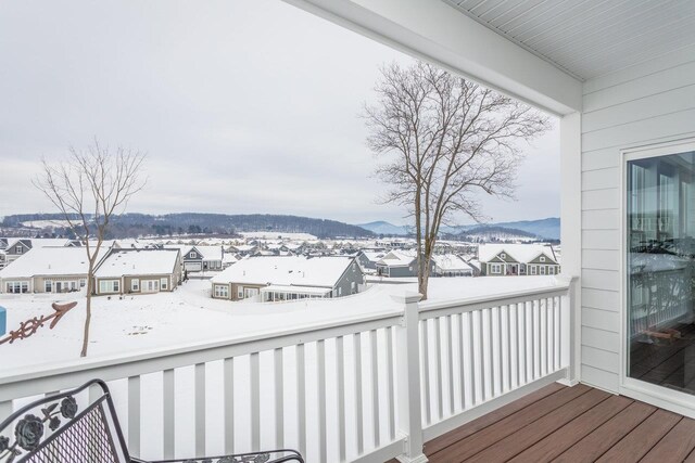 snow covered back of property with a mountain view