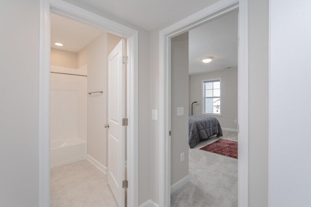 hallway featuring light carpet