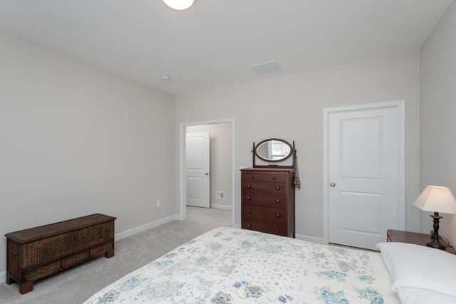 bedroom with light colored carpet