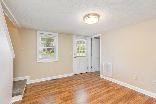 406 6th St, Luray, VA 22835 - entrance foyer featuring light wood-style flooring, a textured ceiling, and baseboards