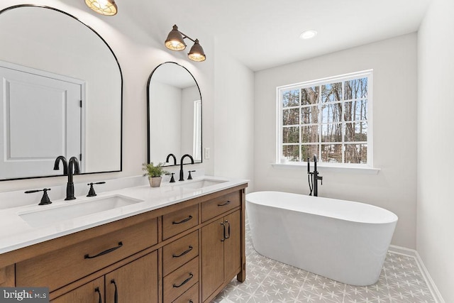 22366 Monrovia Rd, Orange, VA 22960 - bathroom with double vanity, a freestanding bath, baseboards, tile patterned floors, and recessed lighting