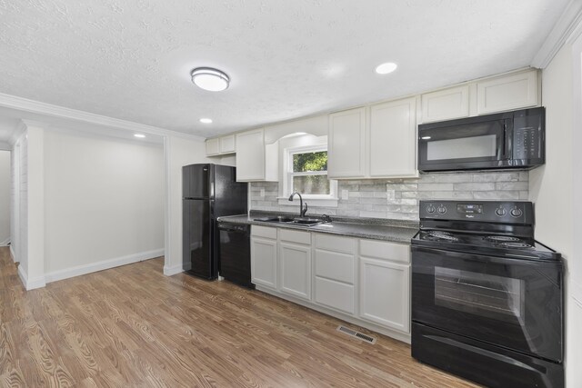 3416 Point Rd E, Elkton, VA 22827 - kitchen with black appliances, dark countertops, backsplash, light wood-style floors, and crown molding