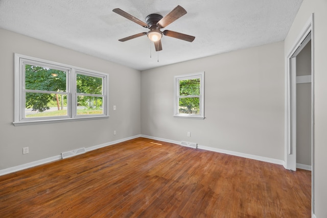 3416 Point Rd E, Elkton, VA 22827 - unfurnished bedroom featuring wood finished floors, a textured ceiling, and a ceiling fan