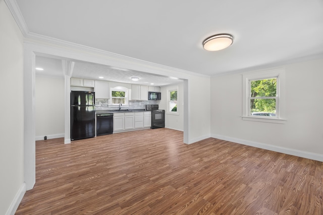 3416 Point Rd E, Elkton, VA 22827 - kitchen with black appliances, white cabinetry, wood finished floors, crown molding, and backsplash