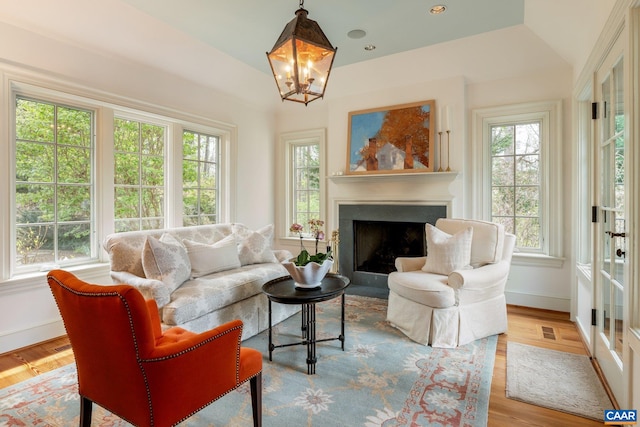 353 Bloomfield Rd, Charlottesville, VA 22901 - living area with a fireplace with flush hearth, baseboards, wood finished floors, lofted ceiling, and a chandelier