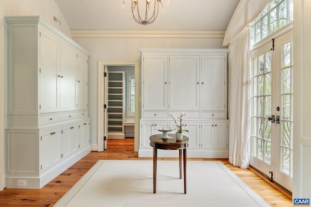353 Bloomfield Rd, Charlottesville, VA 22901 - foyer with light wood-style flooring, a chandelier, french doors, and crown molding