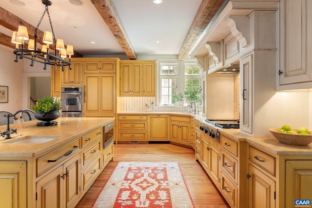 353 Bloomfield Rd, Charlottesville, VA 22901 - kitchen with a sink, appliances with stainless steel finishes, beamed ceiling, light countertops, and light wood-type flooring