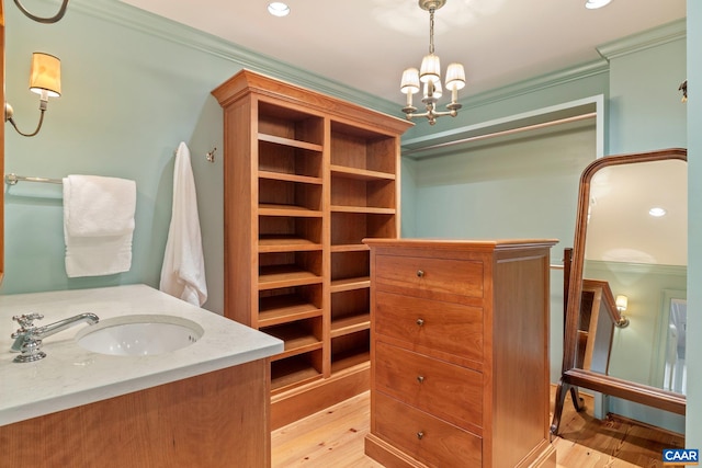 353 Bloomfield Rd, Charlottesville, VA 22901 - bathroom with crown molding, a chandelier, wood finished floors, recessed lighting, and vanity
