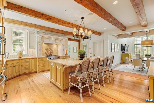353 Bloomfield Rd, Charlottesville, VA 22901 - kitchen with beamed ceiling, light wood finished floors, light countertops, a chandelier, and a kitchen island