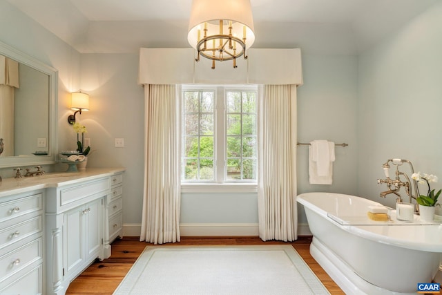 353 Bloomfield Rd, Charlottesville, VA 22901 - full bathroom with a chandelier, wood finished floors, vanity, and a soaking tub