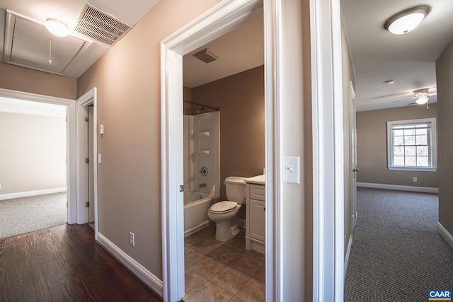 full bathroom featuring toilet, ceiling fan, visible vents, vanity, and bathtub / shower combination