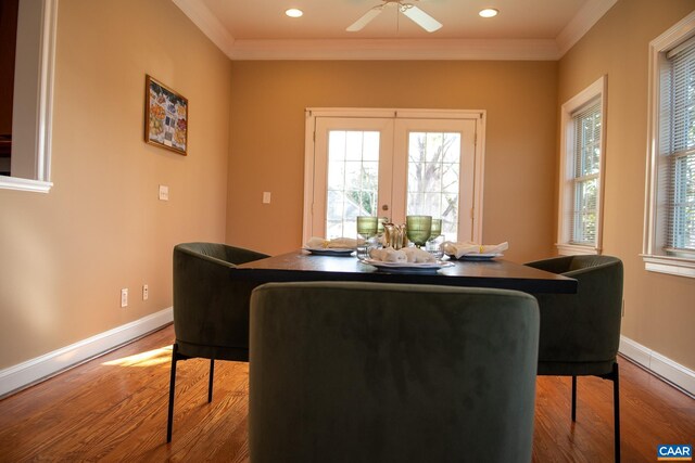 dining space with crown molding, plenty of natural light, and wood finished floors
