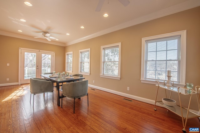 dining space with crown molding, visible vents, baseboards, and a ceiling fan