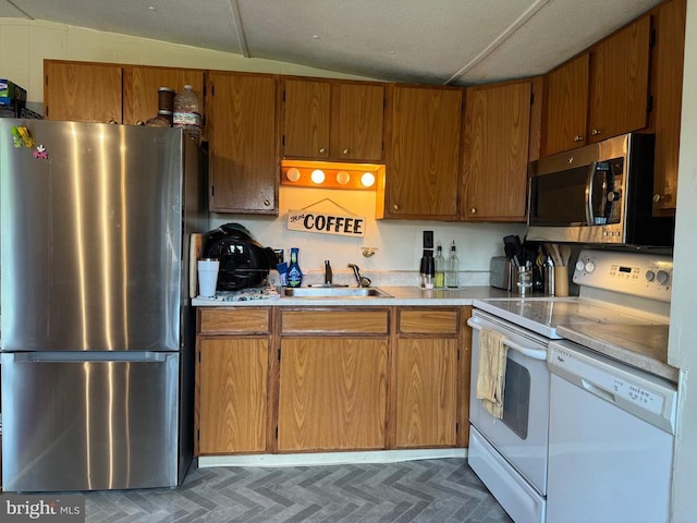 633 Ridge View Ln, Shenandoah, VA 22849 - kitchen featuring appliances with stainless steel finishes, light countertops, brown cabinets, and lofted ceiling