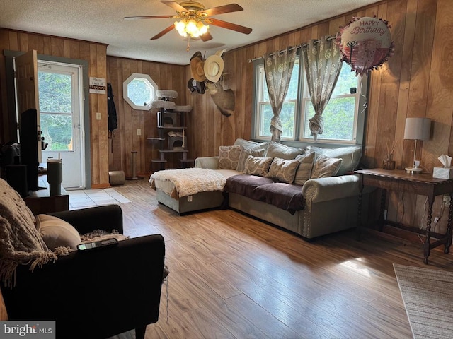 633 Ridge View Ln, Shenandoah, VA 22849 - living room featuring wood walls, ceiling fan, a textured ceiling, and light wood-type flooring