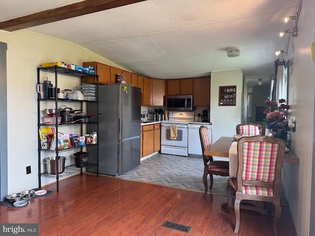 633 Ridge View Ln, Shenandoah, VA 22849 - kitchen with stainless steel appliances, wood finished floors, light countertops, brown cabinets, and lofted ceiling