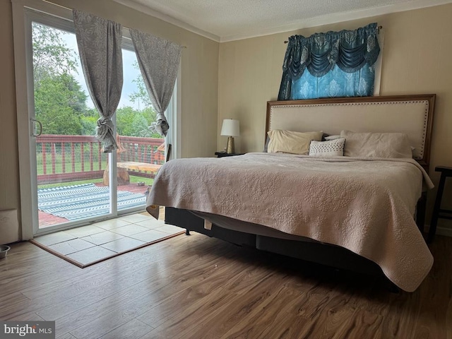 633 Ridge View Ln, Shenandoah, VA 22849 - bedroom with access to exterior, wood finished floors, multiple windows, crown molding, and a textured ceiling