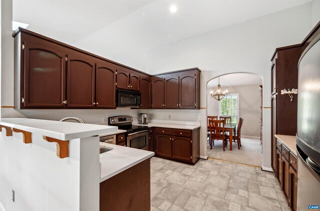 3340 Meadowfield Ln, Charlottesville, VA 22911 - kitchen with black microwave, stainless steel range with electric stovetop, a peninsula, arched walkways, and light countertops