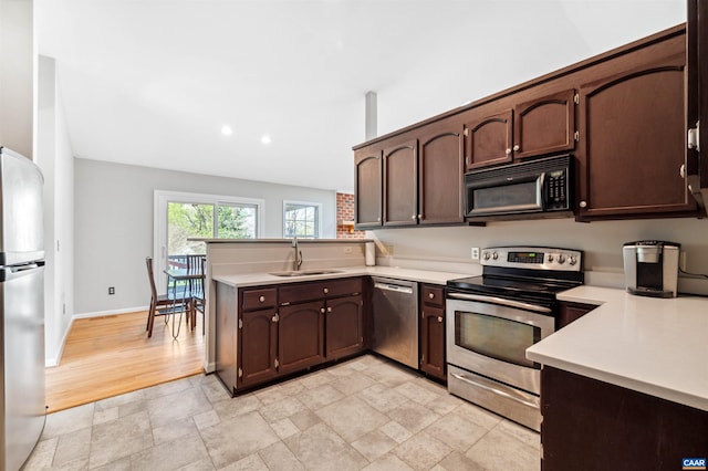 3340 Meadowfield Ln, Charlottesville, VA 22911 - kitchen featuring appliances with stainless steel finishes, a sink, a peninsula, light countertops, and dark brown cabinets
