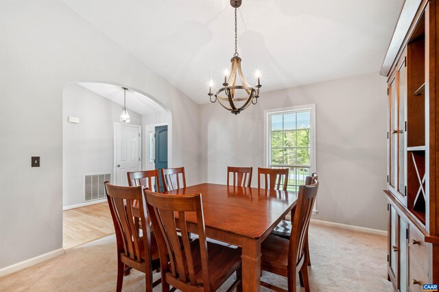 3340 Meadowfield Ln, Charlottesville, VA 22911 - dining area with arched walkways, light colored carpet, a chandelier, and baseboards
