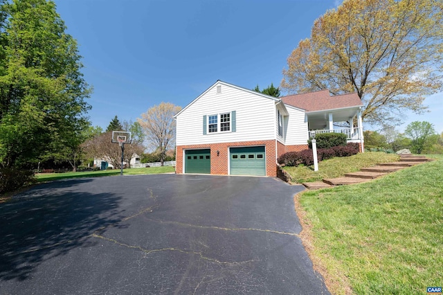 3340 Meadowfield Ln, Charlottesville, VA 22911 - view of side of home with asphalt driveway, a garage, a lawn, and brick siding