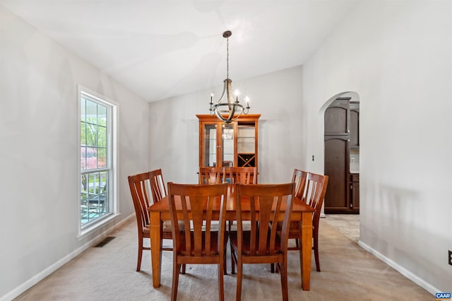 3340 Meadowfield Ln, Charlottesville, VA 22911 - dining space featuring vaulted ceiling, arched walkways, a chandelier, light carpet, and baseboards