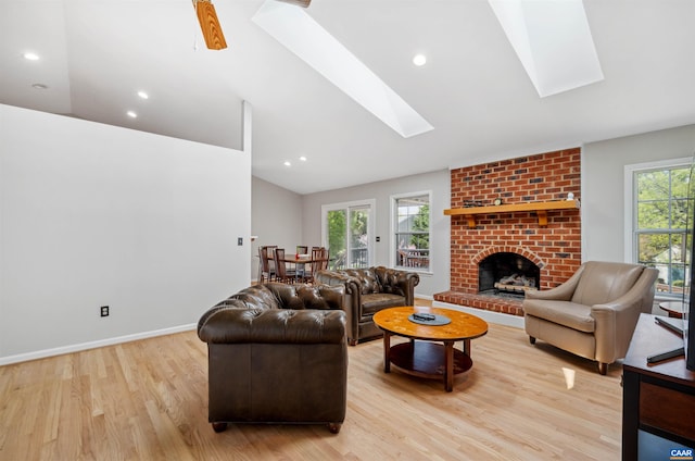 3340 Meadowfield Ln, Charlottesville, VA 22911 - living room with a skylight, vaulted ceiling, light wood-style flooring, a brick fireplace, and recessed lighting