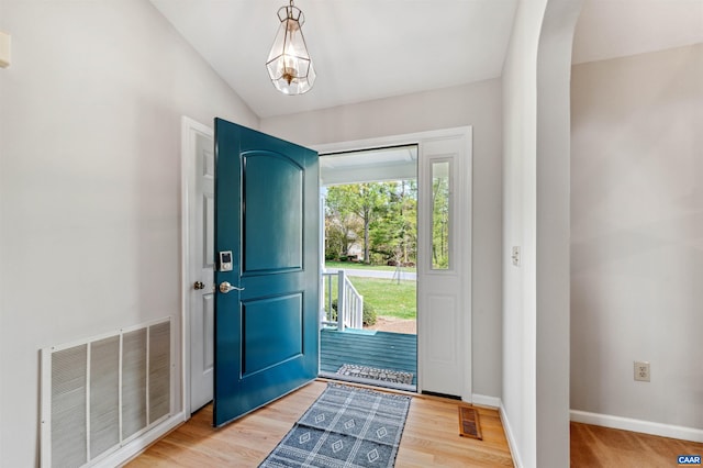 3340 Meadowfield Ln, Charlottesville, VA 22911 - foyer with baseboards, arched walkways, light wood-style floors, lofted ceiling, and a chandelier