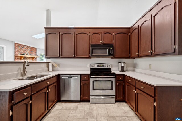 3340 Meadowfield Ln, Charlottesville, VA 22911 - kitchen featuring stainless steel appliances, a sink, a skylight, light countertops, and light stone finish floors