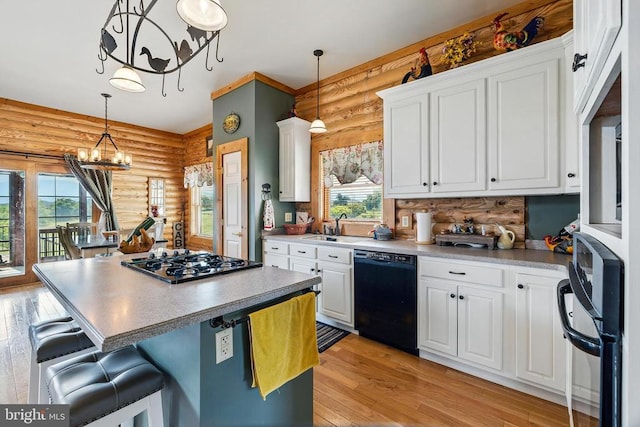 120 Wildflower Ln, Luray, VA 22835 - kitchen featuring black dishwasher, log walls, gas cooktop, light wood-type flooring, and a sink
