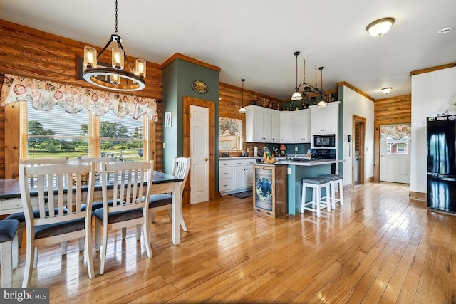 120 Wildflower Ln, Luray, VA 22835 - kitchen featuring black appliances, white cabinets, light wood finished floors, a chandelier, and a kitchen breakfast bar