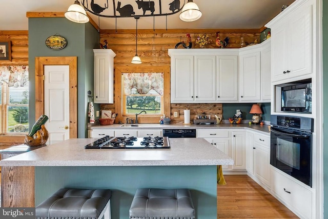 120 Wildflower Ln, Luray, VA 22835 - kitchen with black appliances, a sink, plenty of natural light, and a kitchen breakfast bar